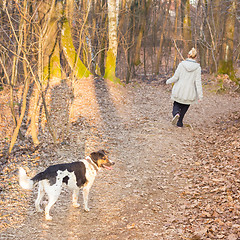 Image showing Woman walking her mixed bred dog.