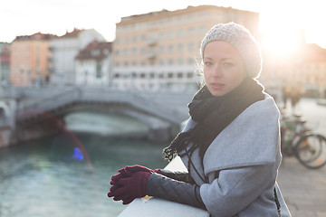 Image showing Thoughtful woman outdoors on cold winter day.