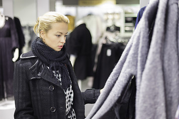 Image showing Beautiful woman shopping in clothing store.