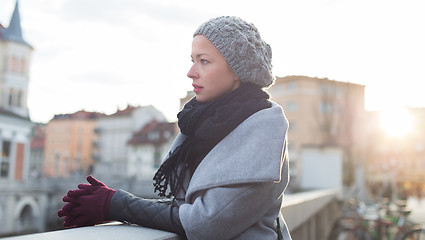 Image showing Thoughtful woman outdoors on cold winter day.