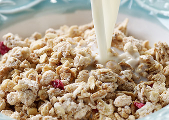 Image showing pouring milk into bowl of muesli