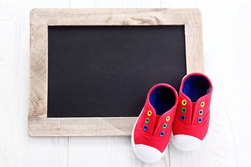 Image showing frame and baby shoes