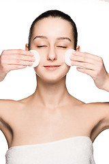 Image showing skin care woman removing face with cotton swabs