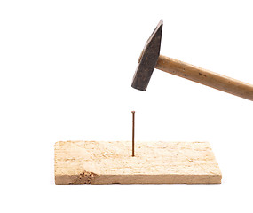 Image showing Hammer with nail and board