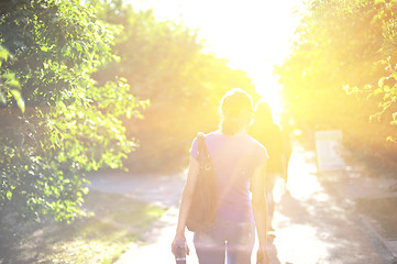 Image showing walking woman on sunrise