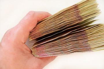 Image showing Ukrainian money of value 100 in the hand isolated