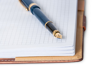 Image showing Closeup fountain pen on top of the open notebook