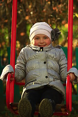 Image showing little girl plays on the swing