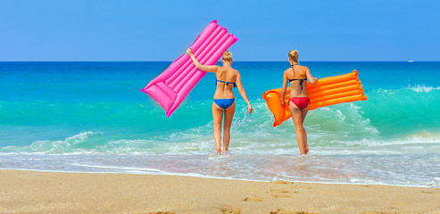 Image showing Beautiful girl in swimsuit are going into the sea