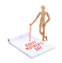 Image showing Wooden mannequin writing in scrapbook - Happy mothers day