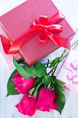 Image showing box for present and red roses 