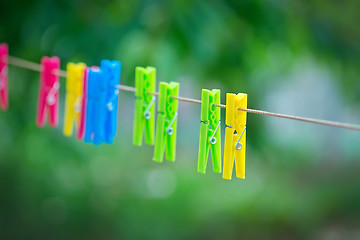 Image showing  colored clothespins on rope