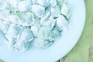 Image showing flour and raw ravioli 