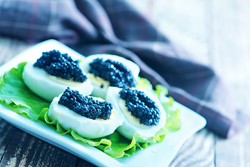 Image showing boiled eggs with caviar