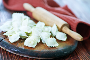 Image showing flour and raw ravioli 