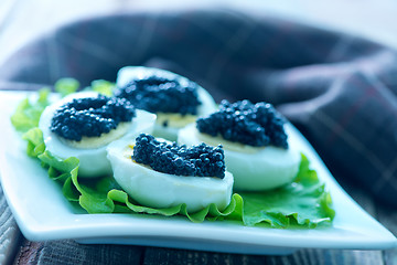 Image showing boiled eggs with caviar