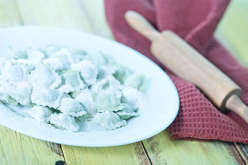 Image showing flour and raw ravioli 