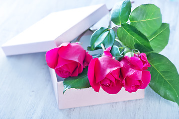 Image showing box for present and red roses 