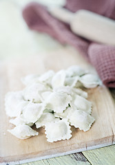 Image showing flour and raw ravioli 