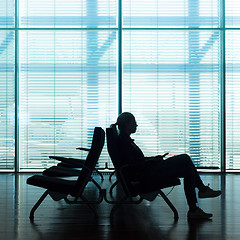 Image showing Woman in transit waiting on airport gate.