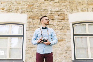 Image showing young hipster man with film camera in city