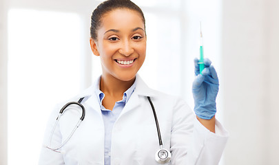 Image showing african doctor holding syringe with injection