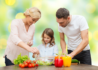 Image showing happy family cooking vegetable salad for dinner