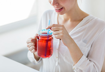 Image showing woman drinking juice from glass mug with straw