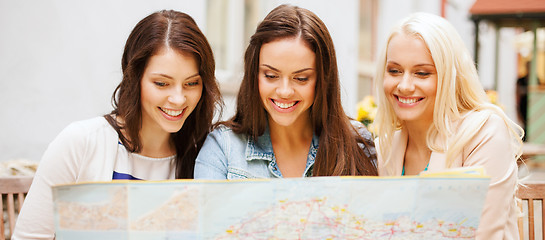 Image showing beautiful girls looking into tourist map in city