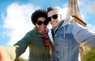 Image showing happy couple taking selfie over eiffel tower