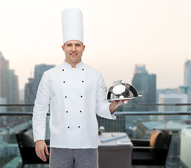 Image showing happy male chef cook holding cloche