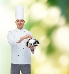 Image showing happy male chef cook holding cloche