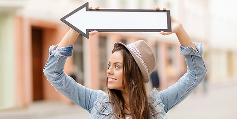 Image showing girl showing direction with arrow in the city