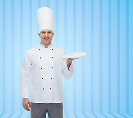 Image showing happy male chef cook showing empty plate