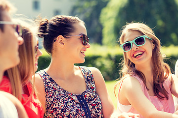 Image showing group of smiling friends outdoors sitting in park