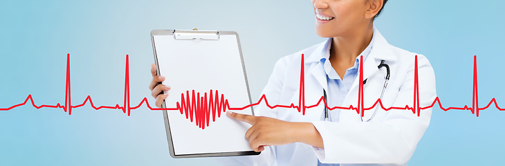 Image showing close up of smiling female doctor with clipboard