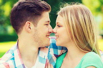 Image showing smiling couple touching noses in park