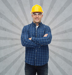 Image showing smiling male builder or manual worker in helmet