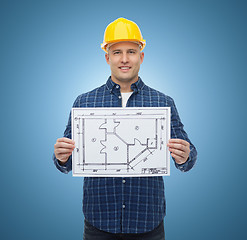 Image showing smiling male builder in helmet with blueprint