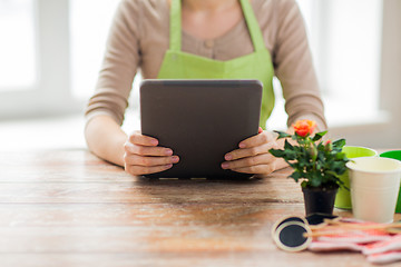 Image showing close up of woman or gardener holding tablet pc