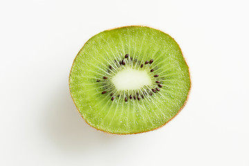 Image showing close up of ripe kiwi slice on table