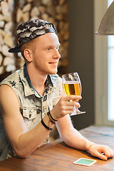 Image showing happy man drinking beer at bar or pub