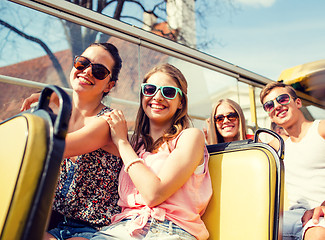 Image showing group of smiling friends traveling by tour bus