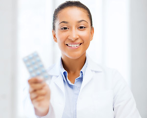 Image showing doctor with blister packs of pills