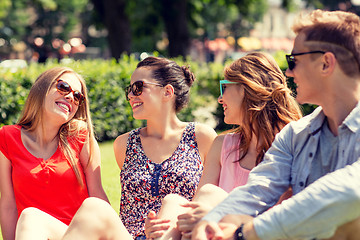 Image showing group of smiling friends outdoors sitting in park