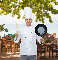 Image showing happy male chef holding frying pan and spatula