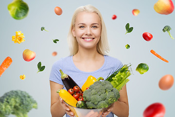 Image showing smiling young woman with vegetables
