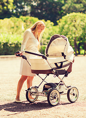 Image showing happy mother with stroller in park