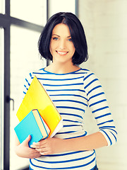 Image showing happy teenage girl with books and folders