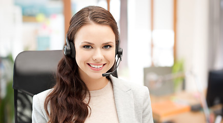 Image showing smiling female helpline operator with headset